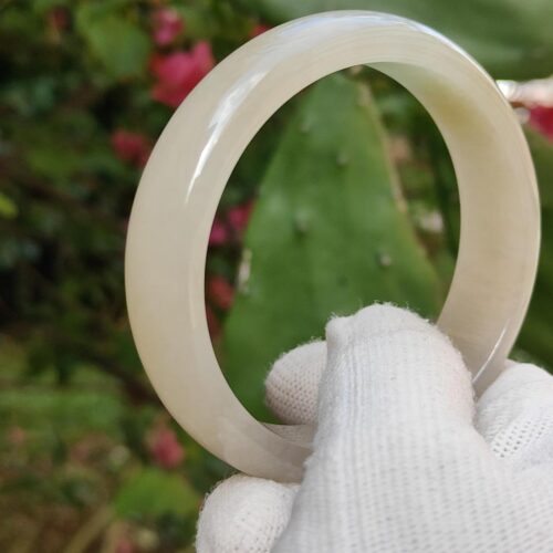 a hand in glove holding a circular object