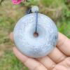a hand holding a round stone