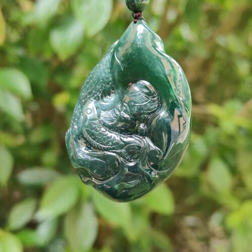 a green stone pendant from a string