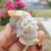 小さな白い石のドラゴンを握っている手