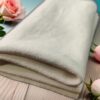 a folded white towel with pink roses