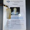 a yellow jade pendant on a white paper