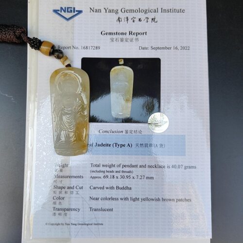 a yellow jade pendant on a white paper