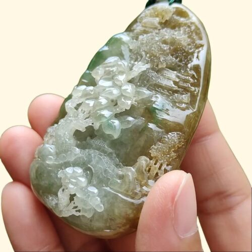 a hand holding a green and white stone