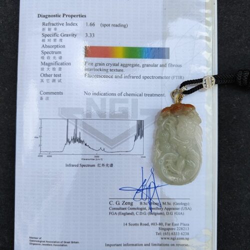 a jade pendant on a book