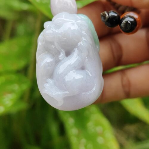 a hand holding a small white stone