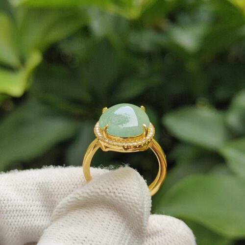 a hand wearing a glove holding a ring