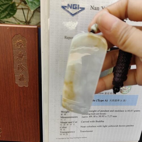 a hand holding a small plastic container