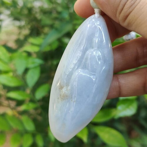 a hand holding a white stone