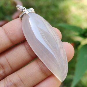 a hand holding a pendant