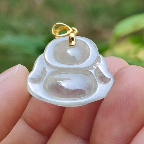 a hand holding a clear pendant