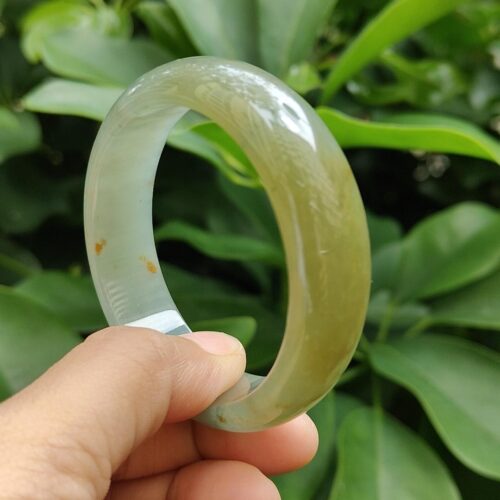 a hand holding a bracelet