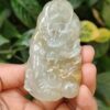 a hand holding a jade object