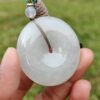 a hand holding a white round object