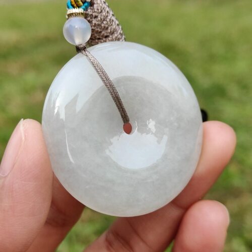 a hand holding a white round object