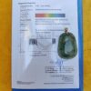 a green jade pendant on a piece of paper