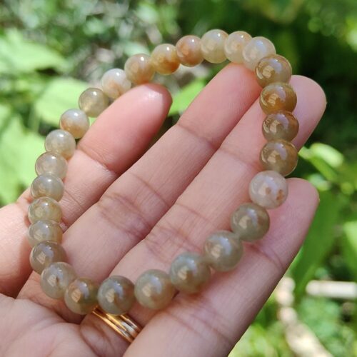 a hand holding a bracelet