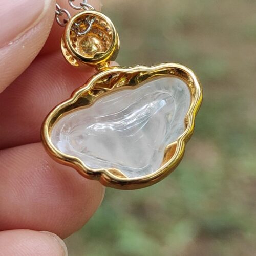 a hand holding a necklace