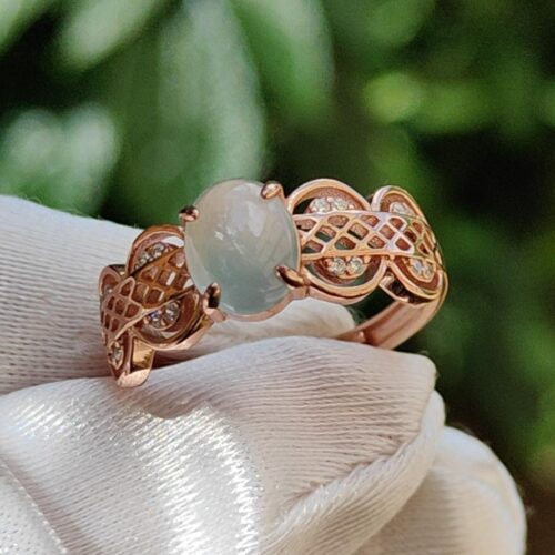 a hand wearing a glove with a ring