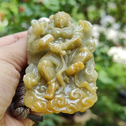 a hand holding a carved stone