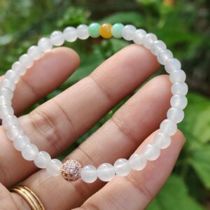 a hand holding a bracelet