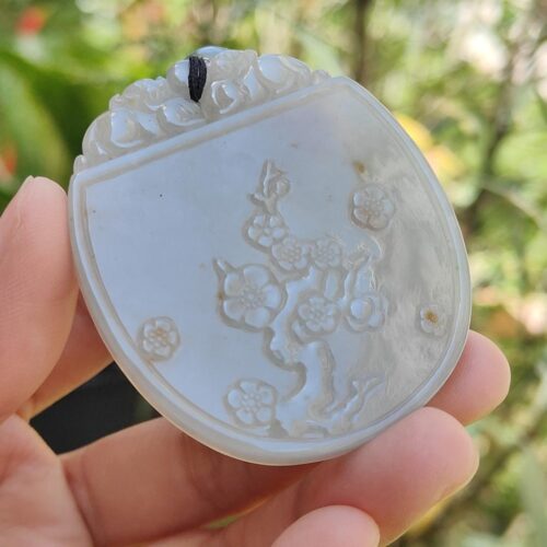 a hand holding a carved white object