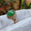 a ring with a green stone on it