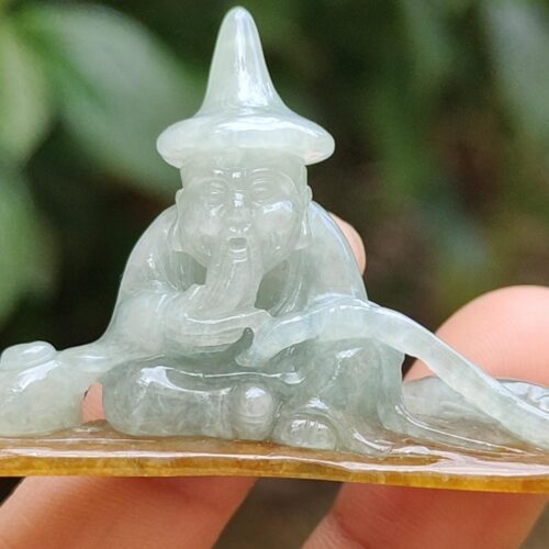 a person holding a small statue
