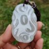 a hand holding a carved stone