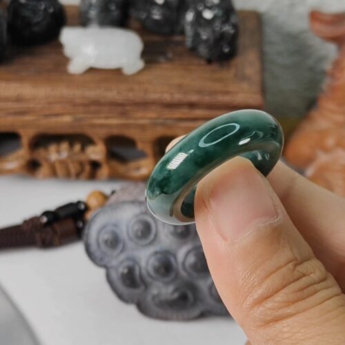 a person holding a jade ring