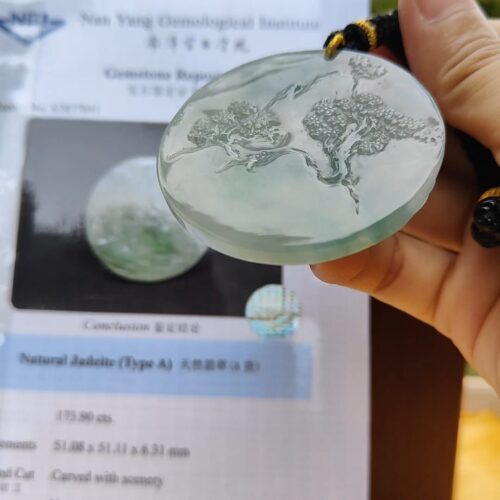 a hand holding a piece of glass