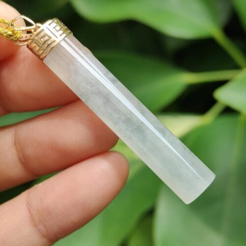 a hand holding a crystal necklace