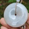 a hand holding a white round object