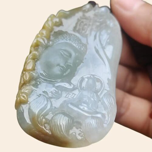 a hand holding a carved stone