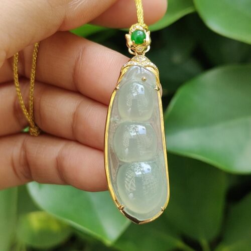 a hand holding a necklace