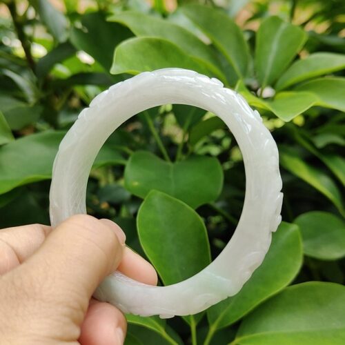 a hand holding a white circular object