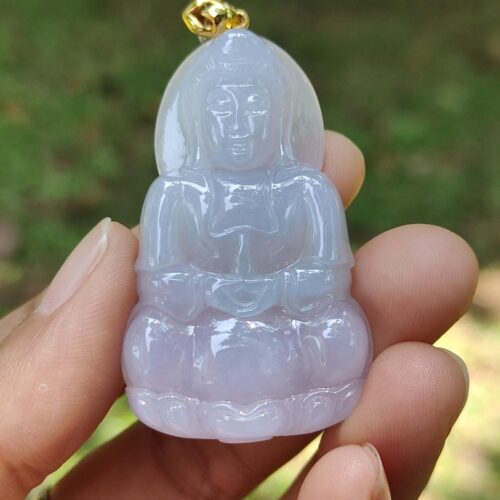 a person holding a jade pendant