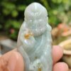 a person holding a small statue