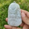 a hand holding a carved white stone