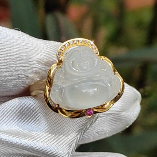 a hand wearing a white glove with a white jade ring