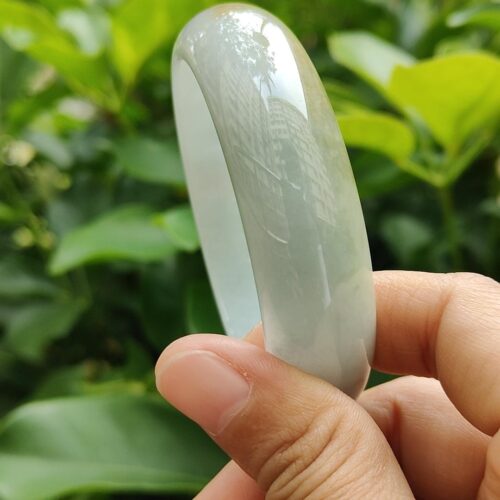 a hand holding a clear plastic ring