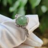 a ring with a green stone on it