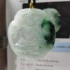 a jade pendant with a person in the middle