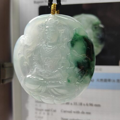 a jade pendant with a person in the middle