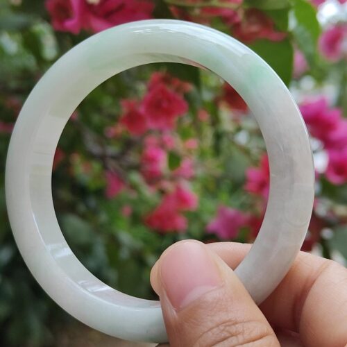 a hand holding a white circular ring