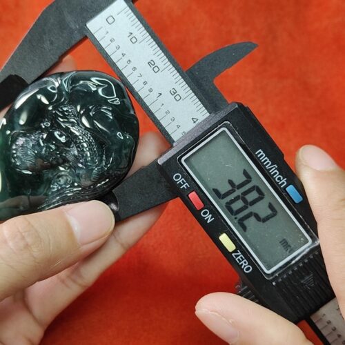 a person measuring a piece of stone