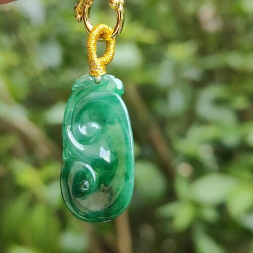 a close up of a jade pendant