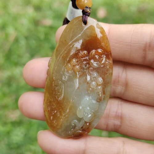 a hand holding a stone necklace