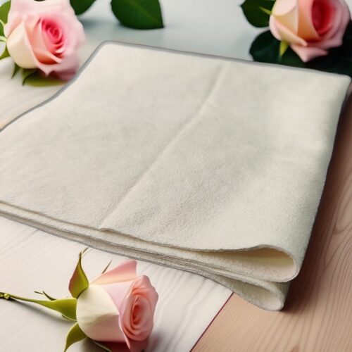 a white towel with pink roses on a table