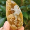a hand holding a carved stone